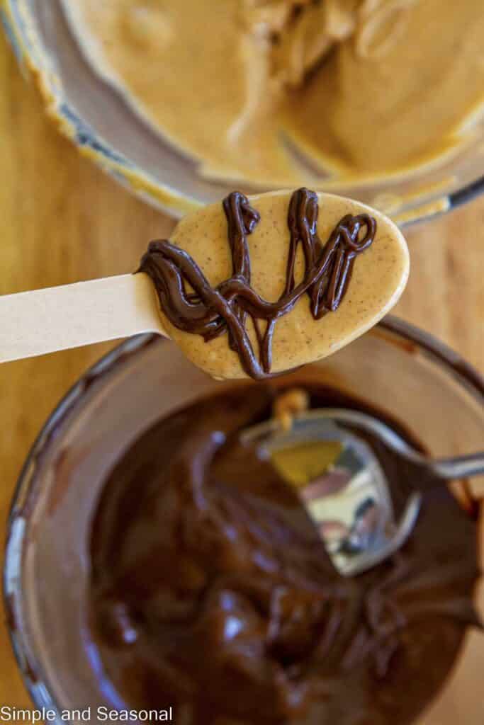 chocolate drizzled over melted peanut butter spoon