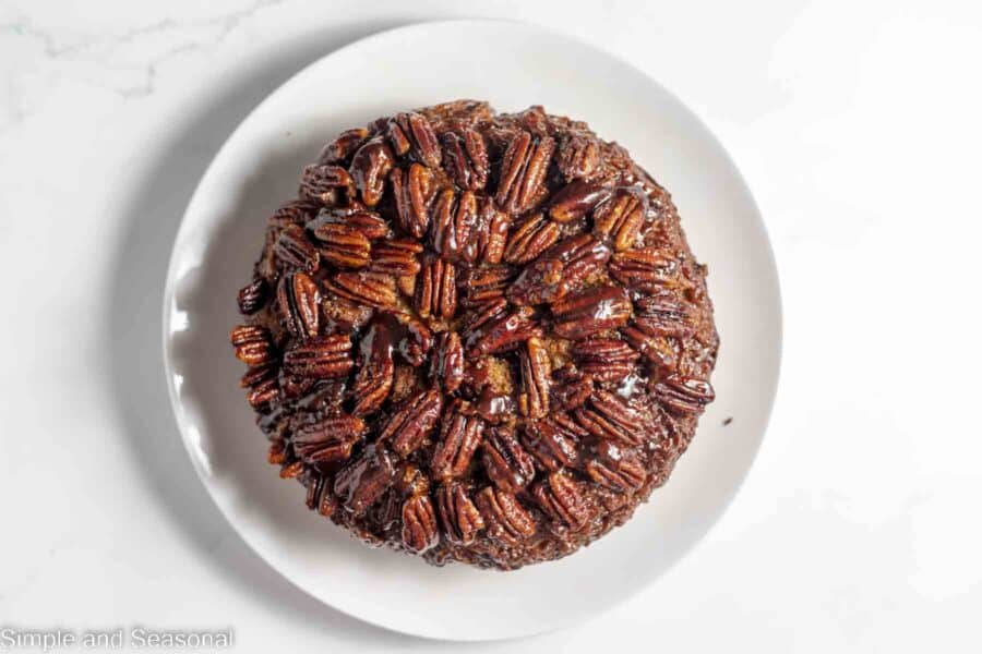 pecan cake flipped over onto plate