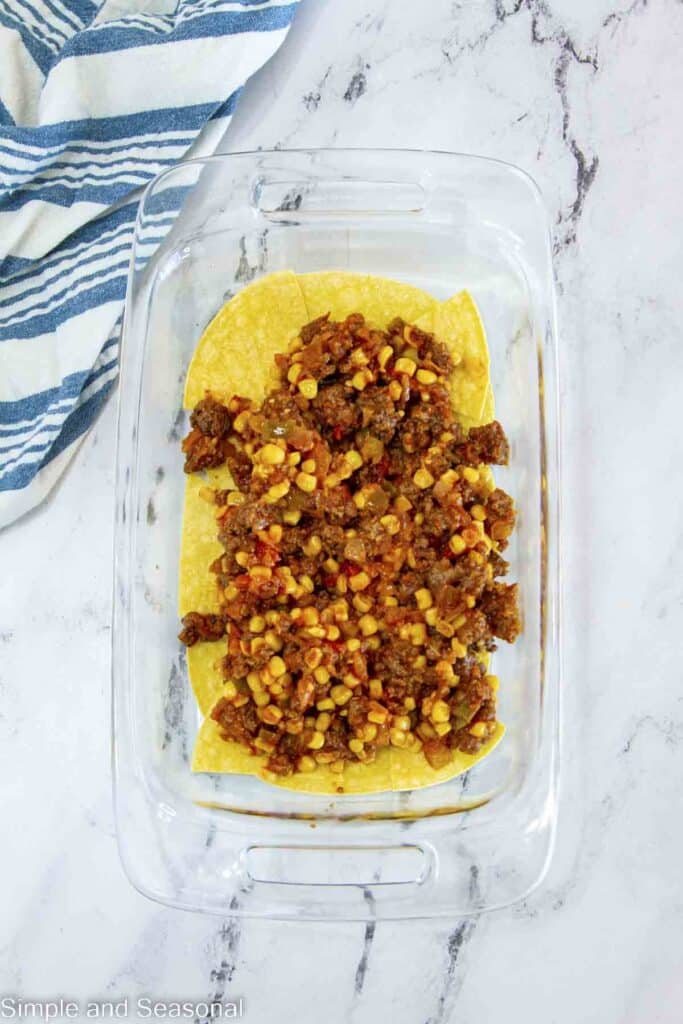 meat mixture layered on top of tortillas