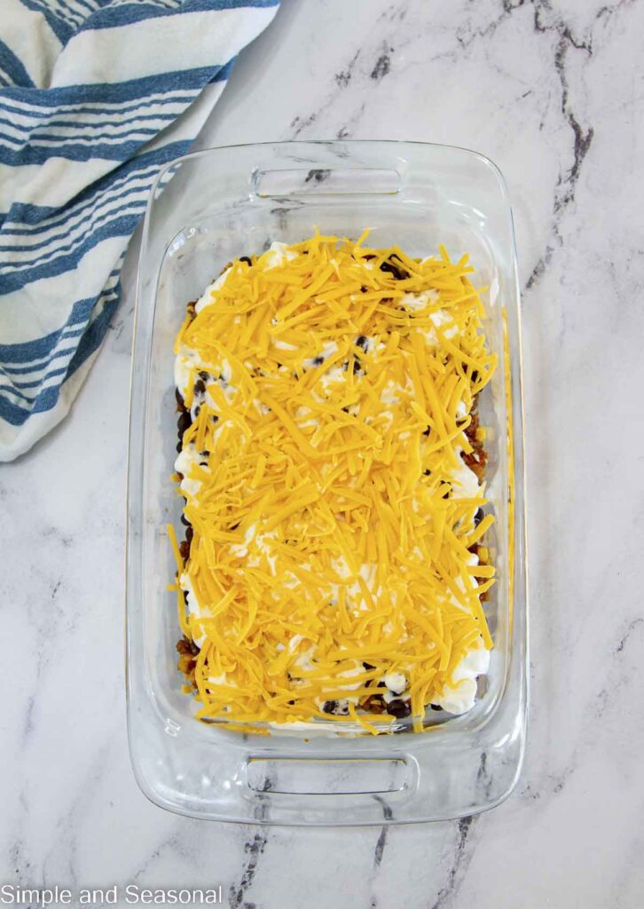 shredded cheese on top of cream layer