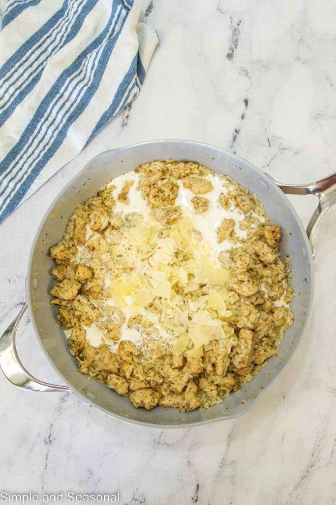 cream and cheese added to chicken and rice mixture in the skillet