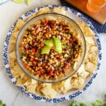 top down view of bowl of bean salad on a blue and white platter